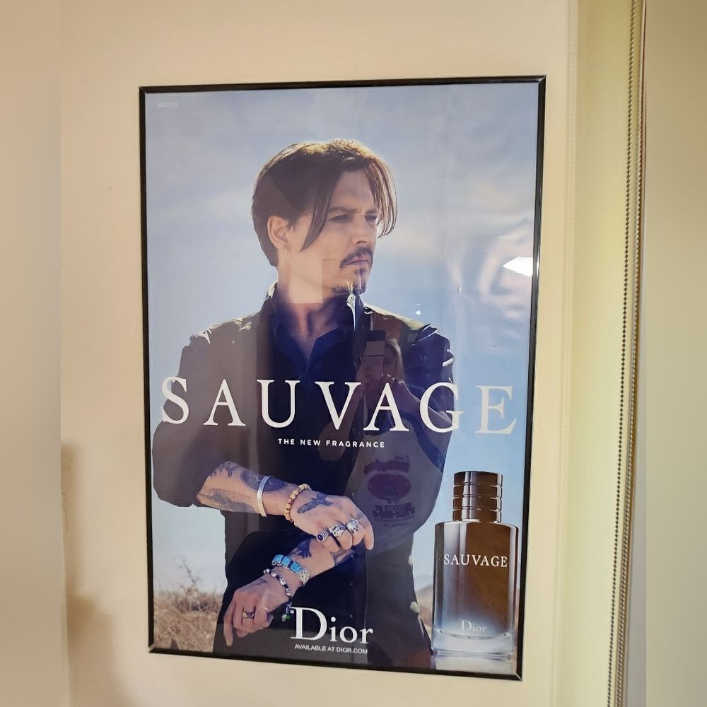 Dior Sauvage Fragrance Advertisement with Blue and Black Accents